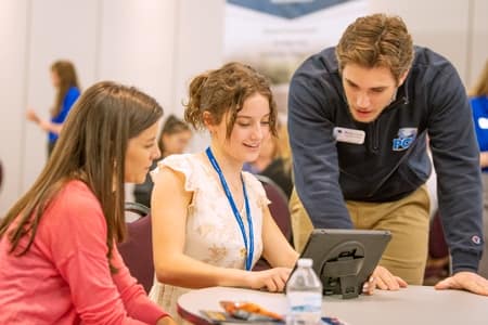 Admissions Counselors helping student set up