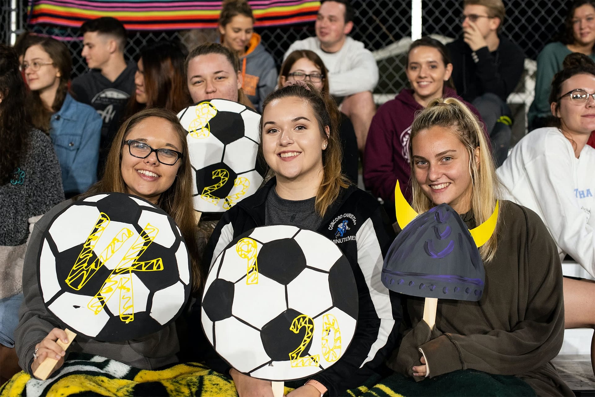 Watching students cheered on the Vikings with handmade signs
