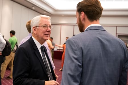 Dr. Dale Adkins talking with student