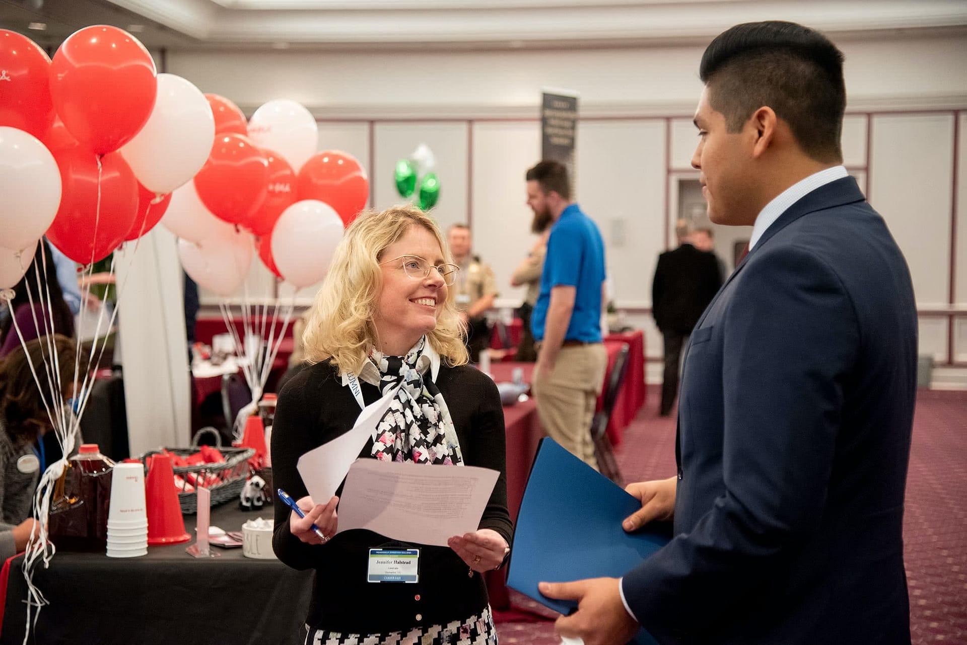 PCC senior speaking at a booth with a business representative at the 2020 Career Fair. 
