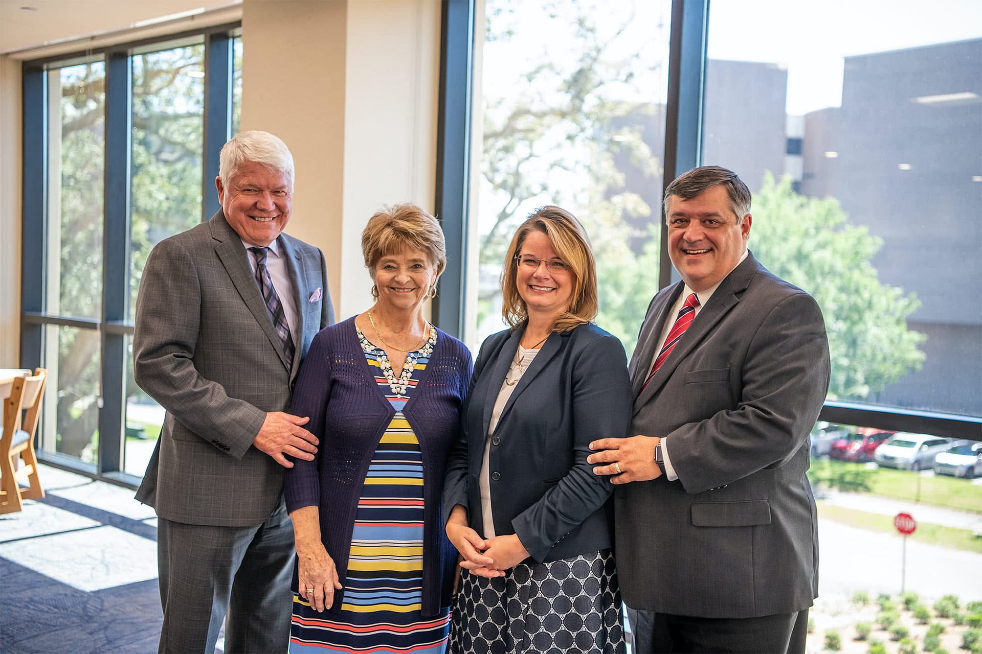Dr. Bill Rice, III and his wife posing for a photo with Dr. Shoemaker and his wife. 