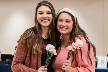 Students receiving flowers at the Mission Project Flower Fundraiser event. 
