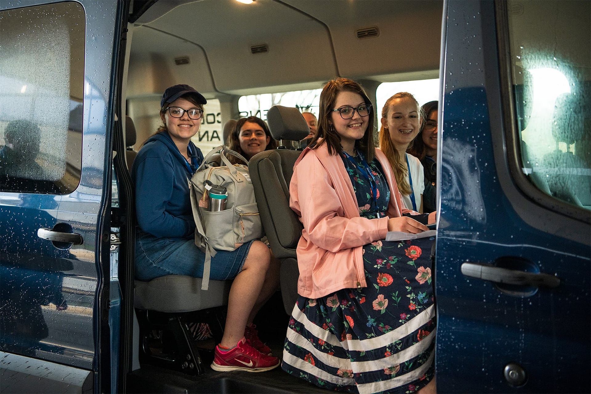High School students sitting in a PCC van.