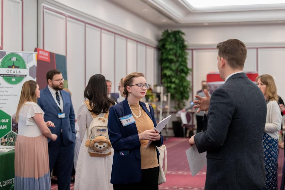 Student talks with a recruiter at PCC's Educator Recruitment event