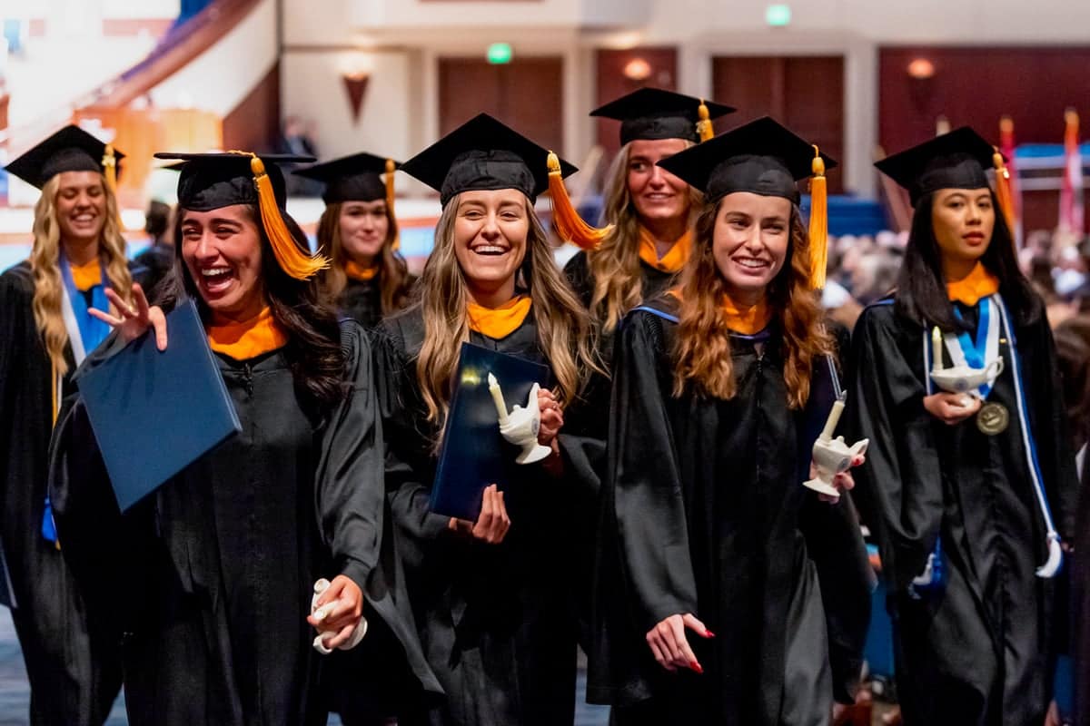 nursing--lamps 2024 Nursing Graduates walk with their lamps during Commencement
