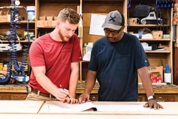 Cabinet Shop Supervisor Jordan Jekel with a fellow PCC staff employee.