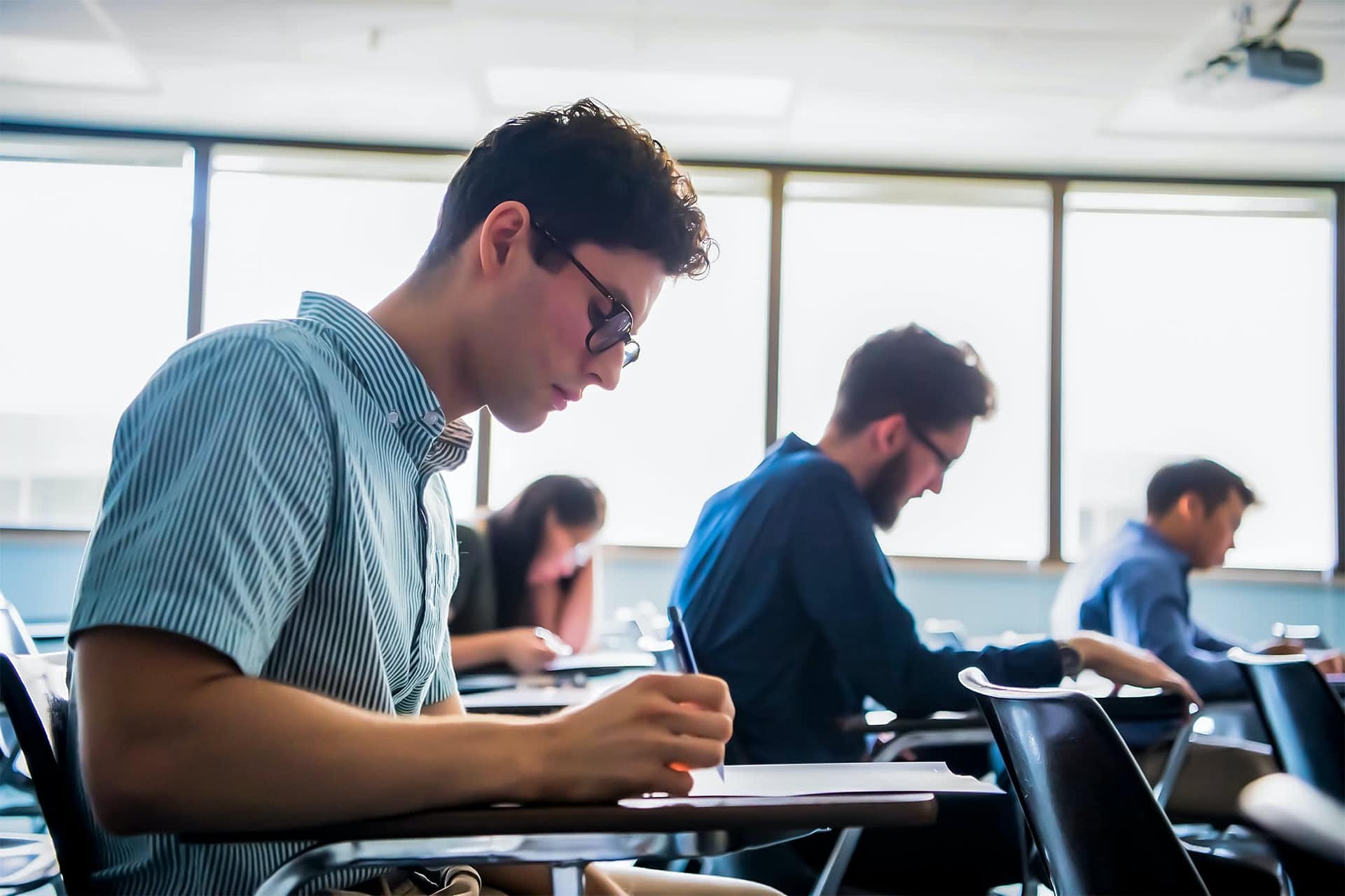 Graduate students sitting at desks.