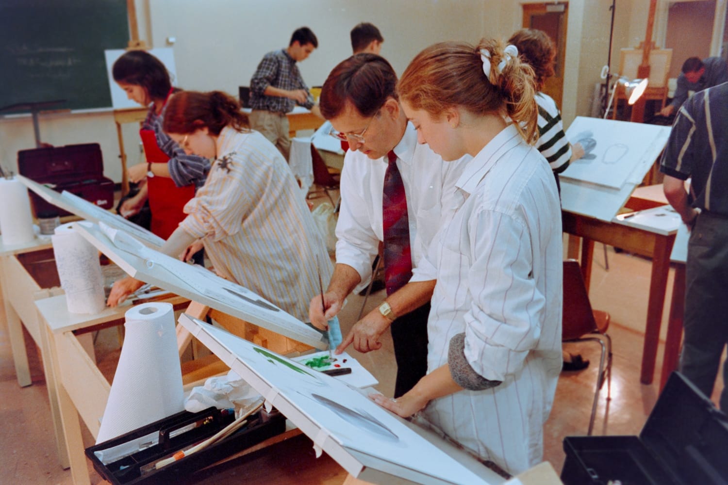Stan Shimmin helping a student in an art class.