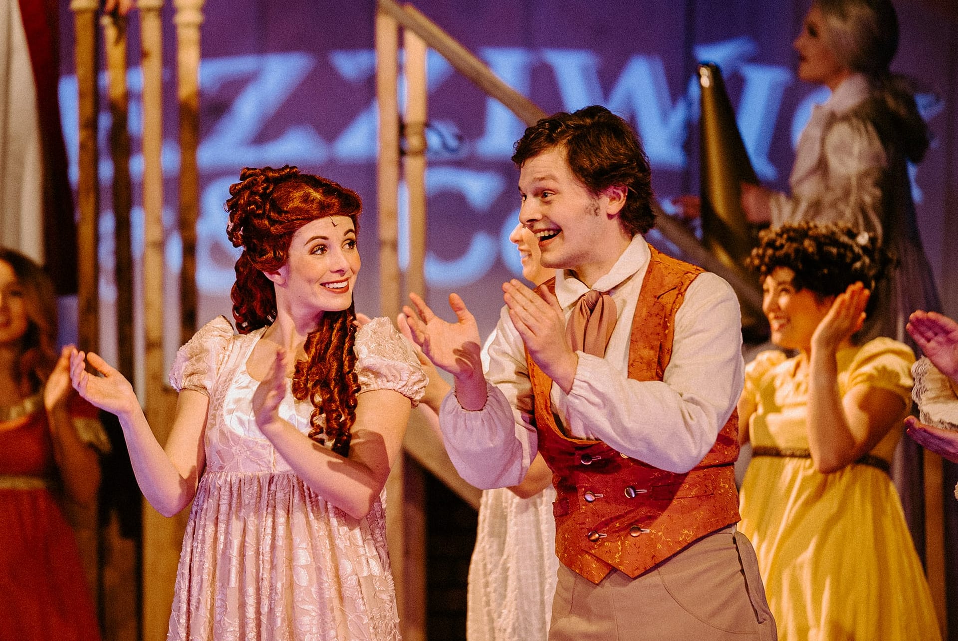 Young Scrooge and girlfriend clapping