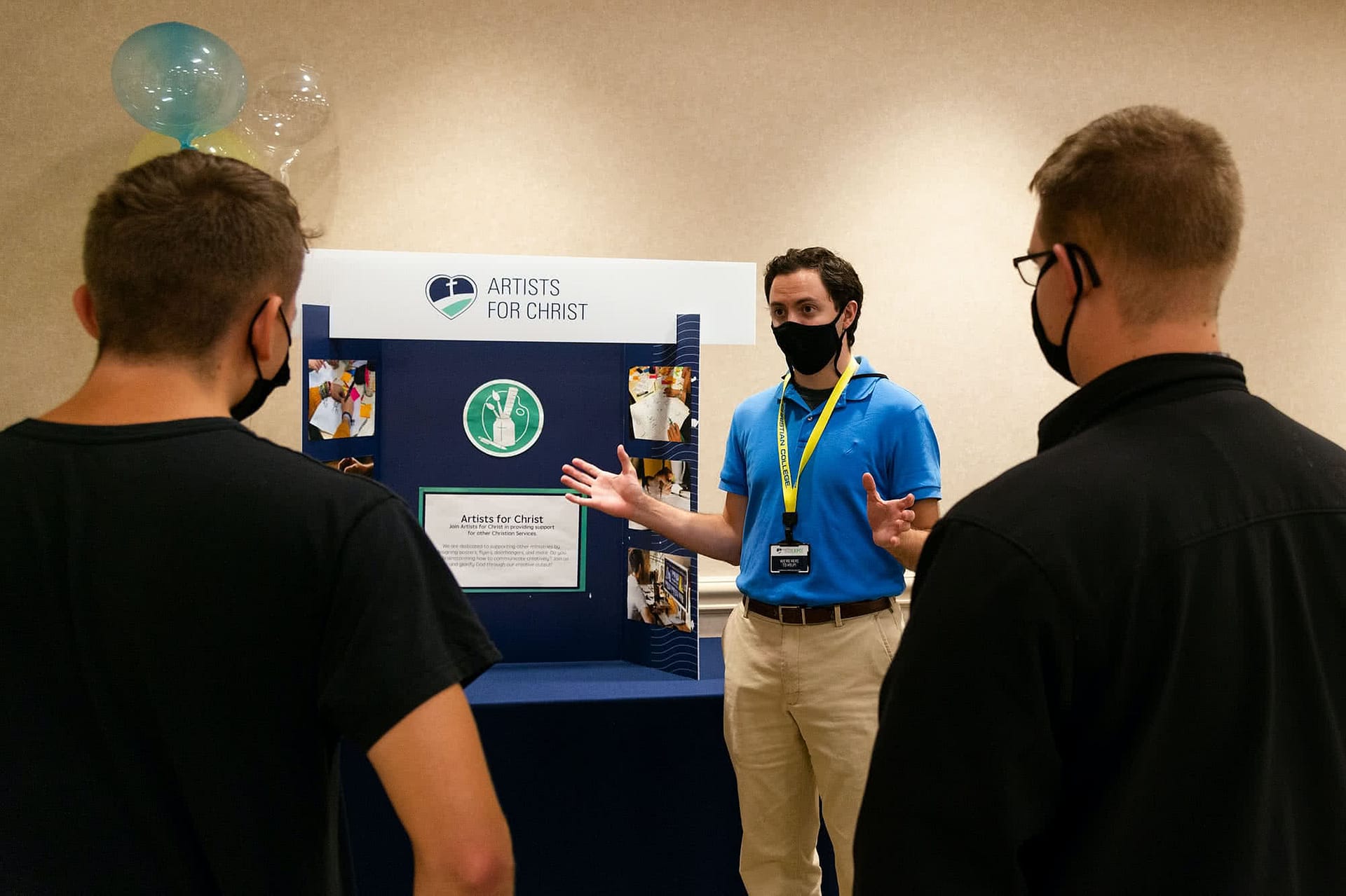 Students consider joining the "Artists for Christ" Christian service group at the Christian Service expo