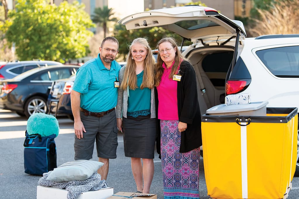 New student with parents unloading car.