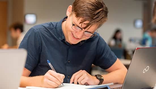 Student studying in Commons