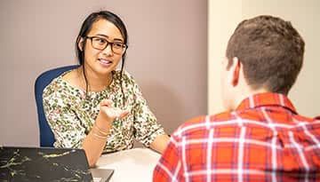 A tutor helps a student iin the Academic Advising Office