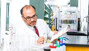 Dr. Sean Vinaja working in a lab.