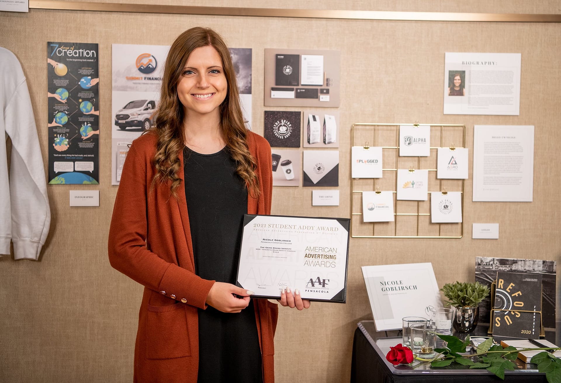 Nicole Goblirsch poses with her Addy Award and art projects.