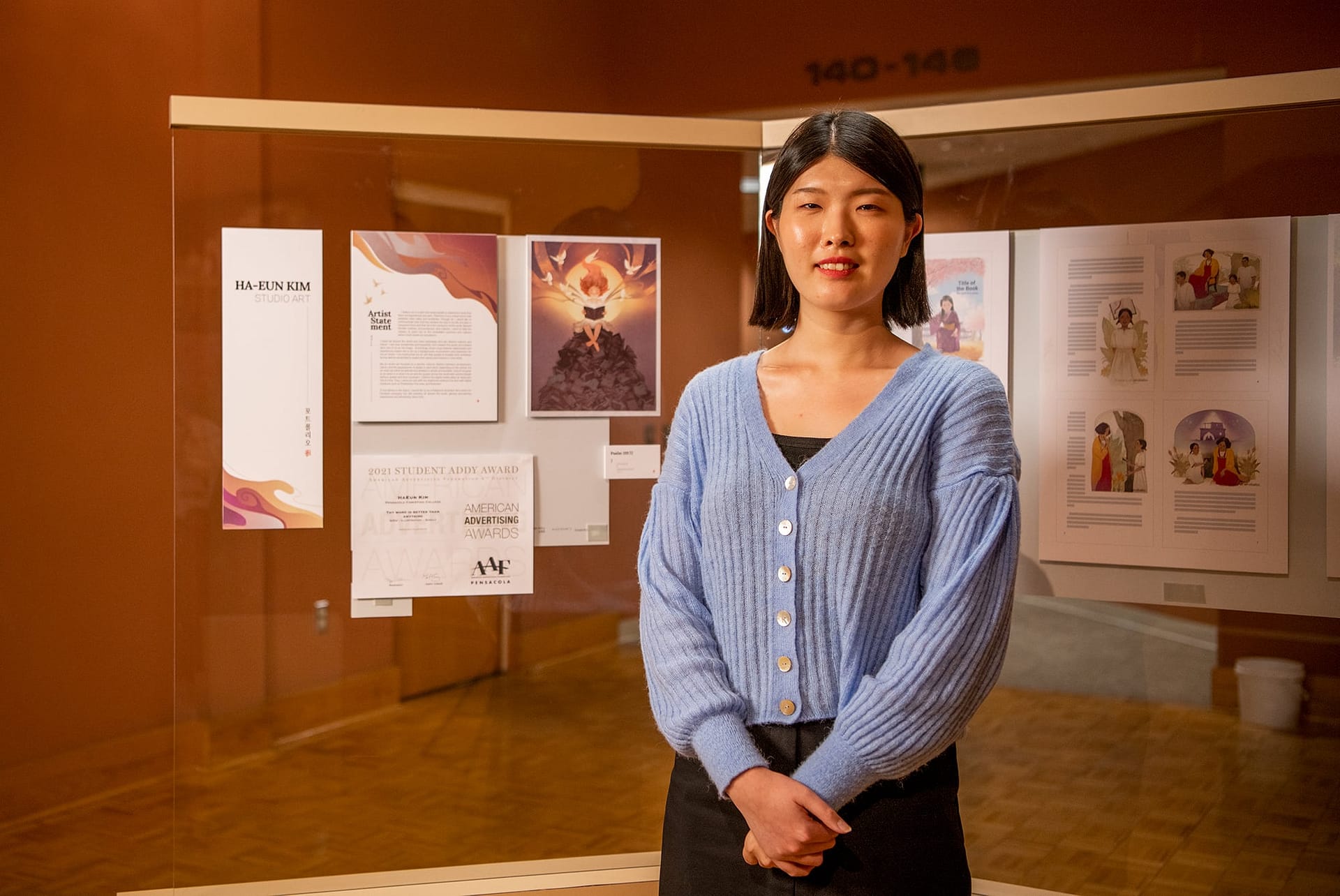 Ha-Eun Kim stands with her art display.