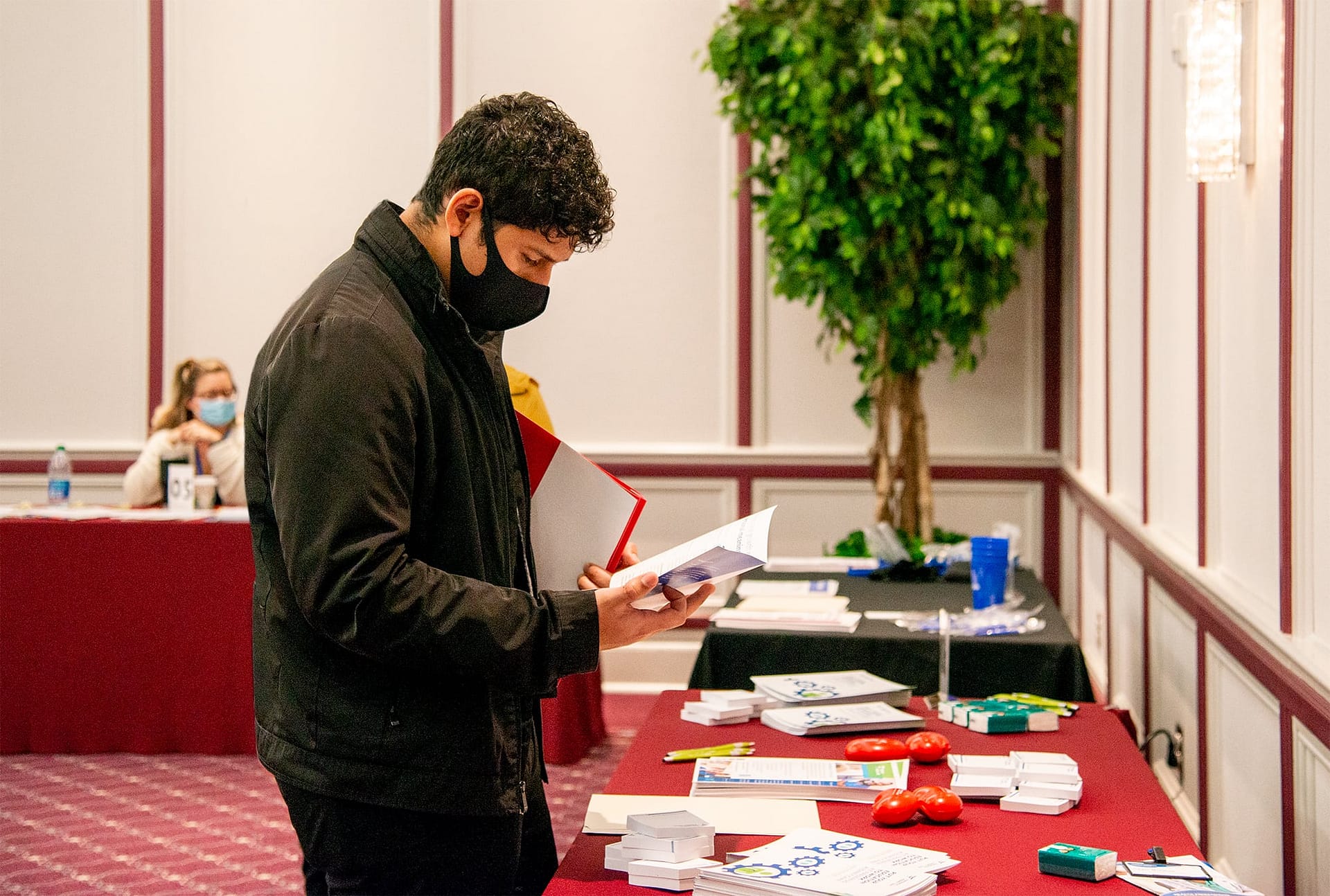 Male student looking at a pamphlet.