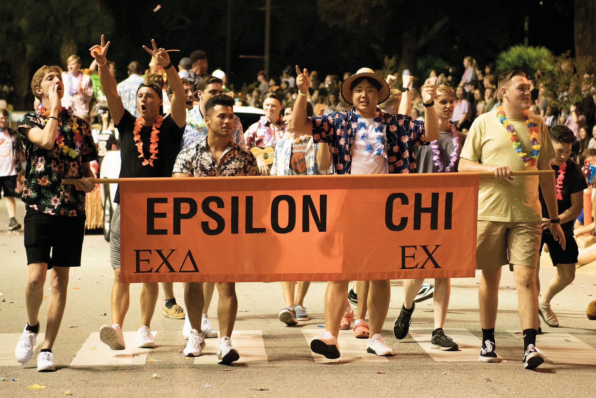 Group of boys with Epsilon Chi banner during Greek Rush parade..