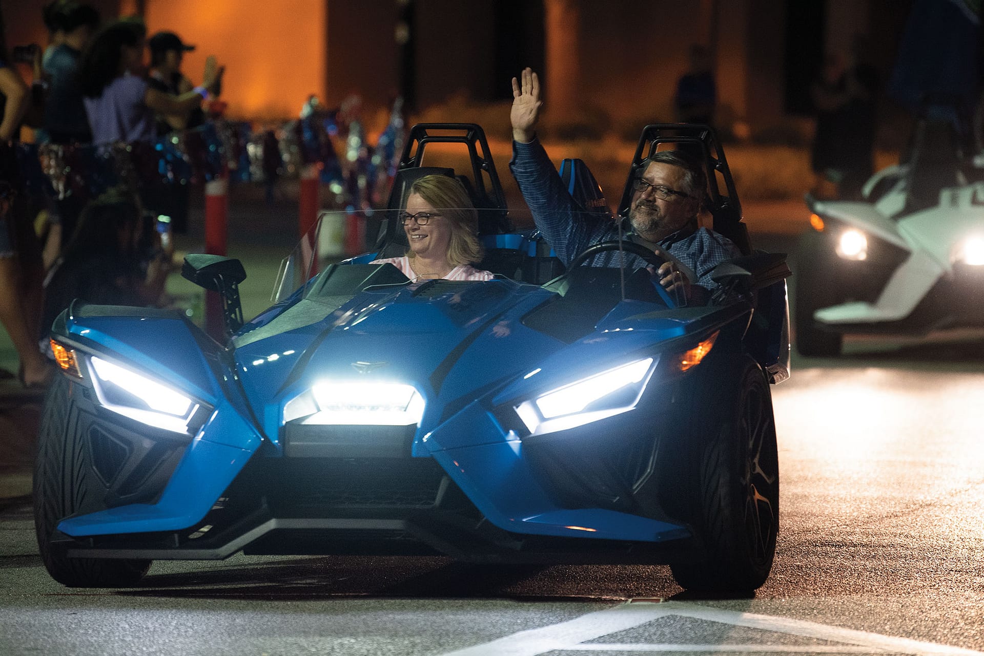 Dr. and Mrs. Shoemaker in a car in the 2021 Greek Rush Parade.