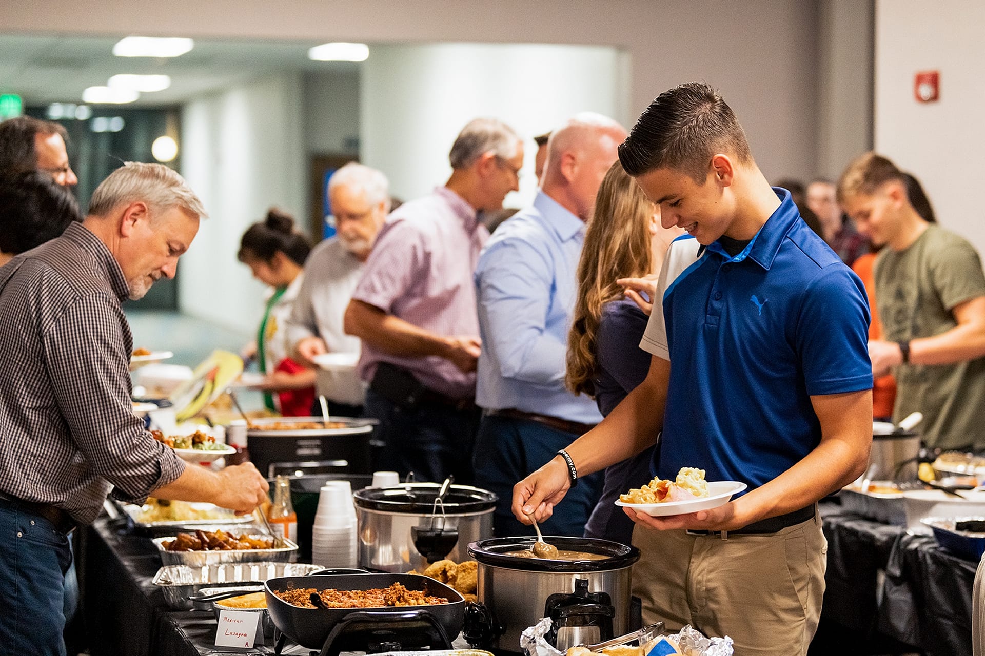 People serving themselves food at the Missionary dinner.
