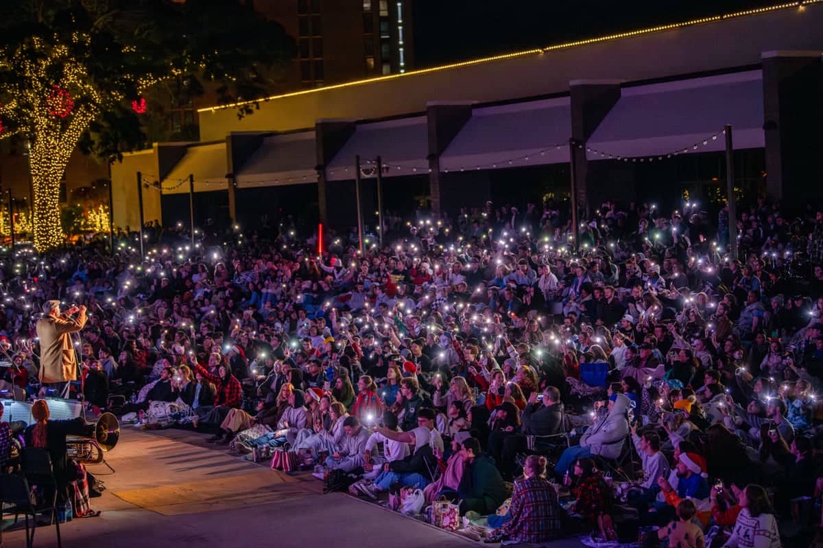 PCC Students wave their phones during the Christmas Lights Celebration 2024