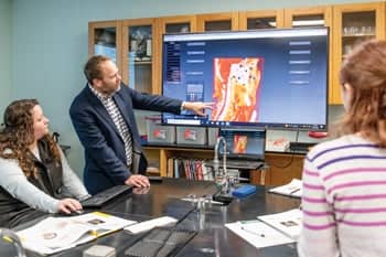 Mr. Benjamin Reid instructs his students how to think through concepts in an anatomy and physiology lecture.