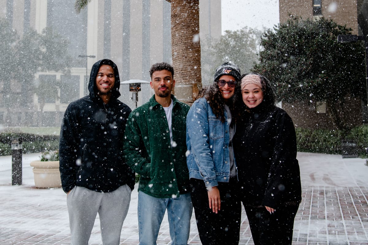 PCC Students enjoy the snow by the Academic Building.