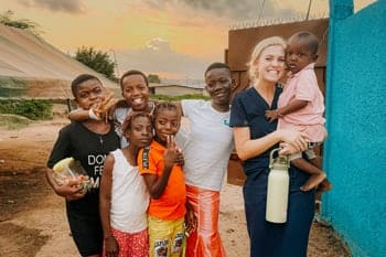 On a missions trip, alumna Mekenzie Olinger engages with West African children.