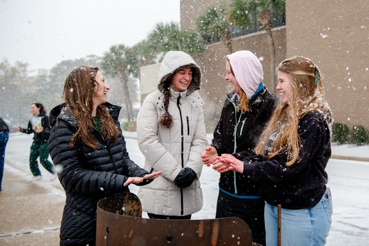 PCC girls warm their hands as they enjoy their snow day.