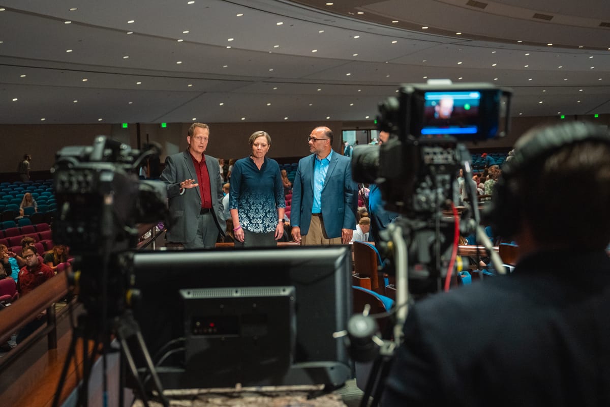 PCC Faculty take a moment to do a live streaming broadcast before the Answers in Genesis event at PCC.