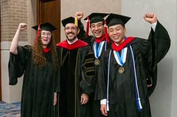 Graduate pose for a photo at the Arts and Science PCC Commencement 2025