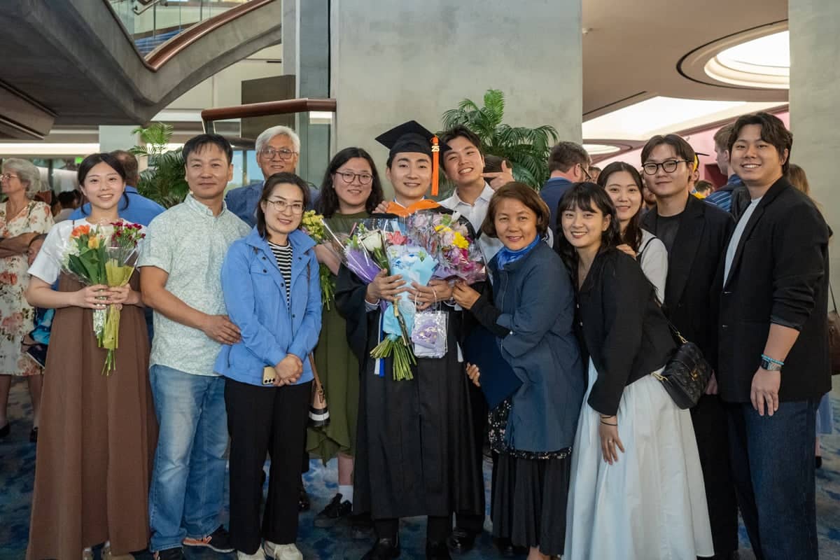 Graduate poses with his family at the PCC Commencement 2025