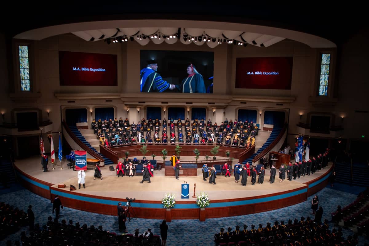 Graduates walk across the stage at the Arts and Science PCC Commencement 2025