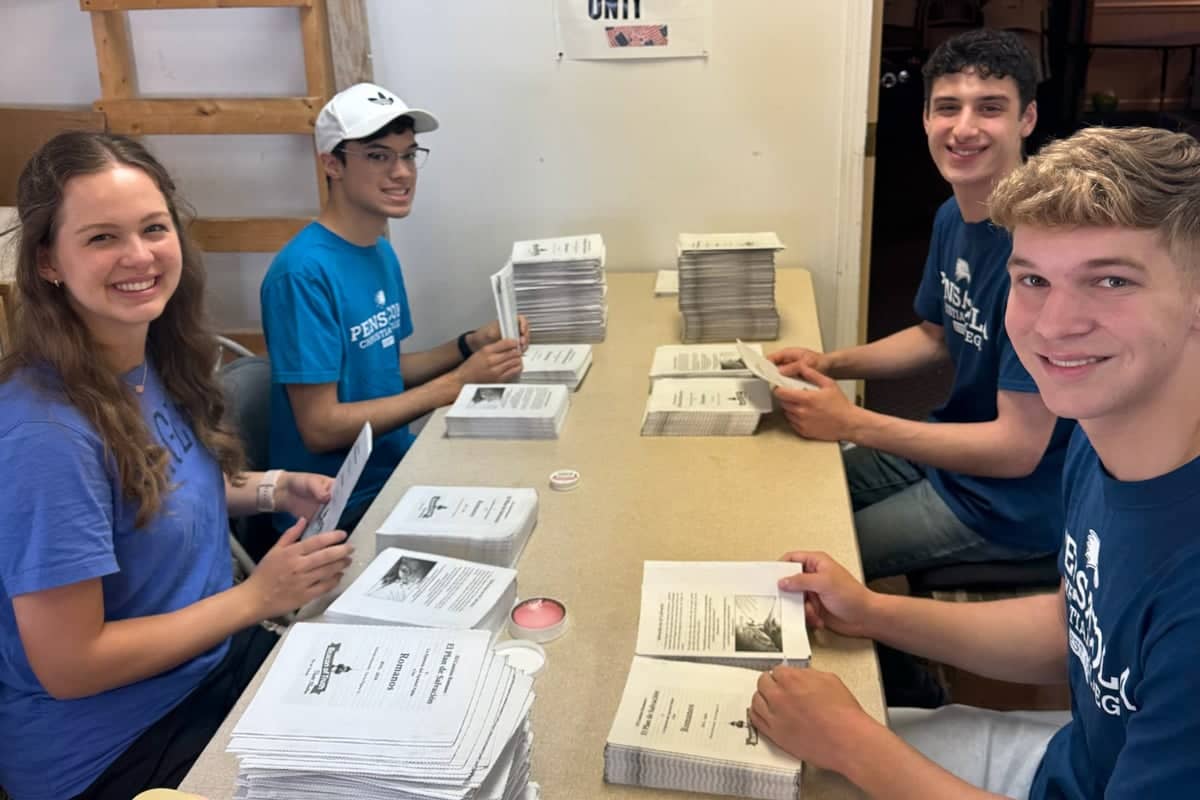 PCC Proclaim Team members help to assemble bibles.
