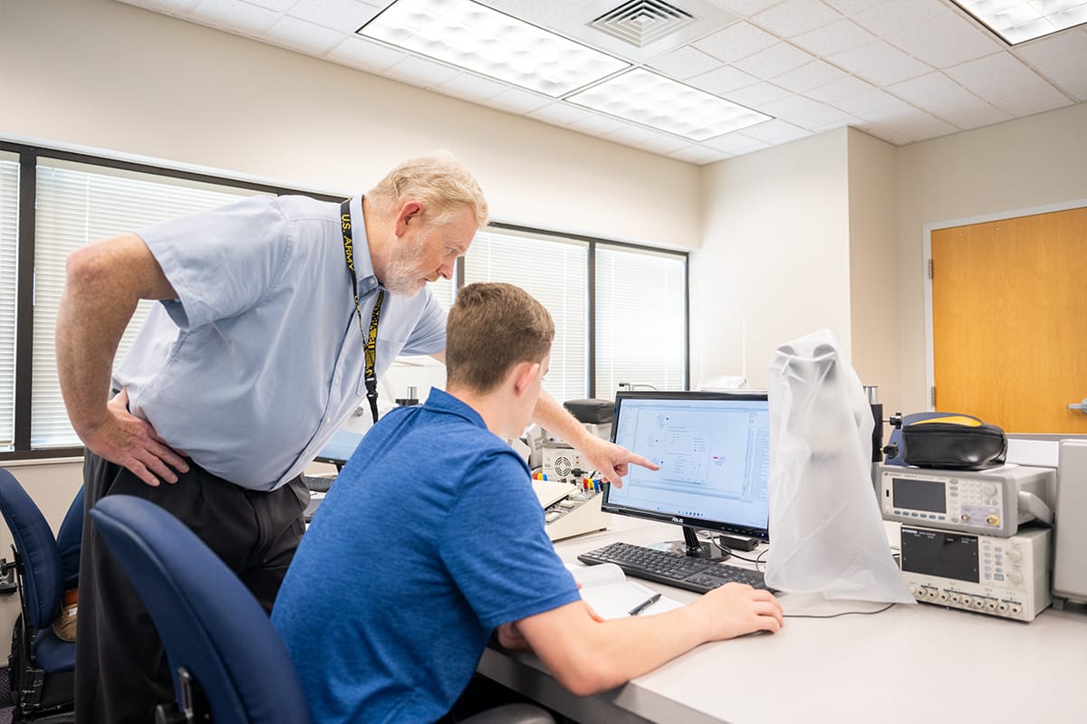 PCC faculty helping student with project