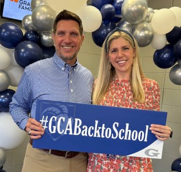 Alumni Anthony Lamb with back to school sign