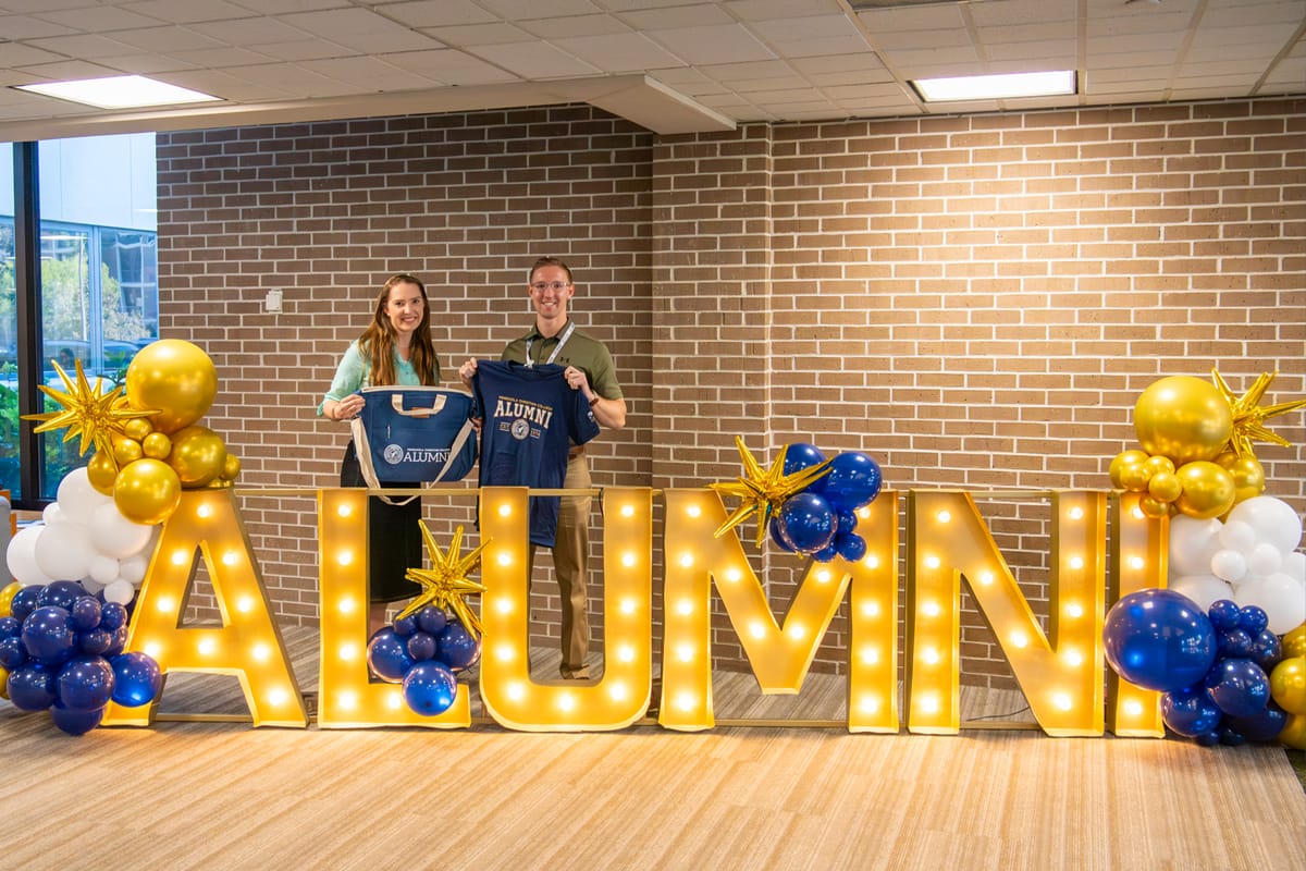 PCC alumni with homecoming gifts