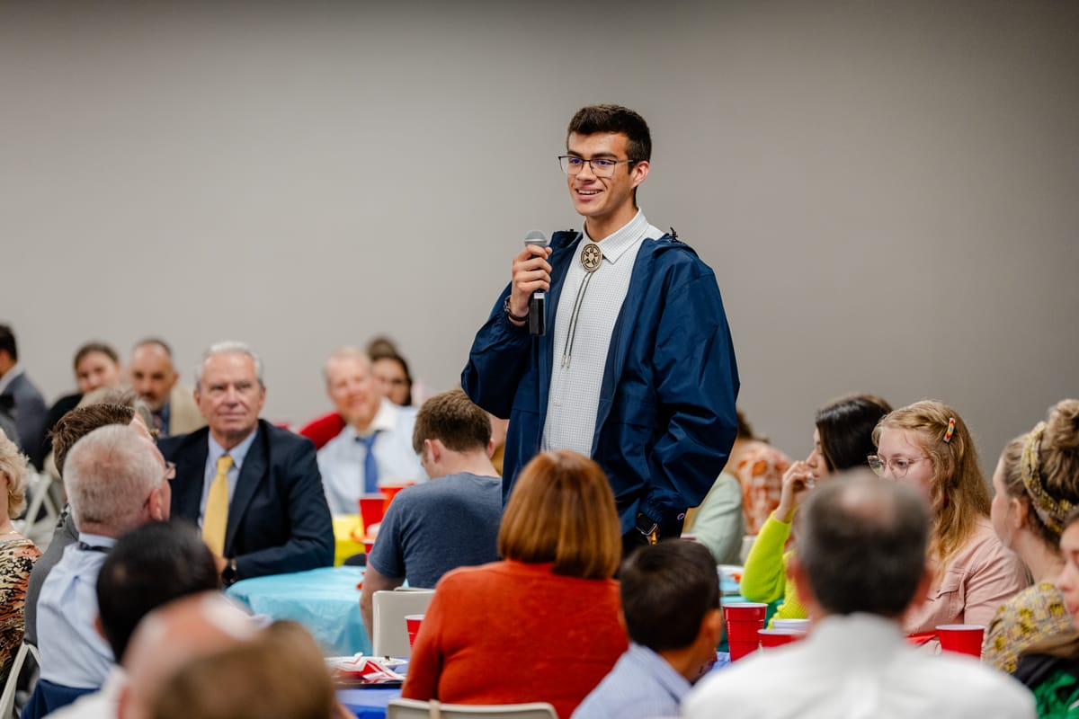 Student speaking at Missionary Kid's Lunch