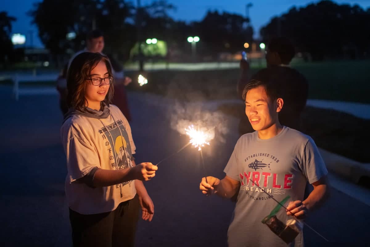 PCC summer workers enjoy an evening playing with sparklers.