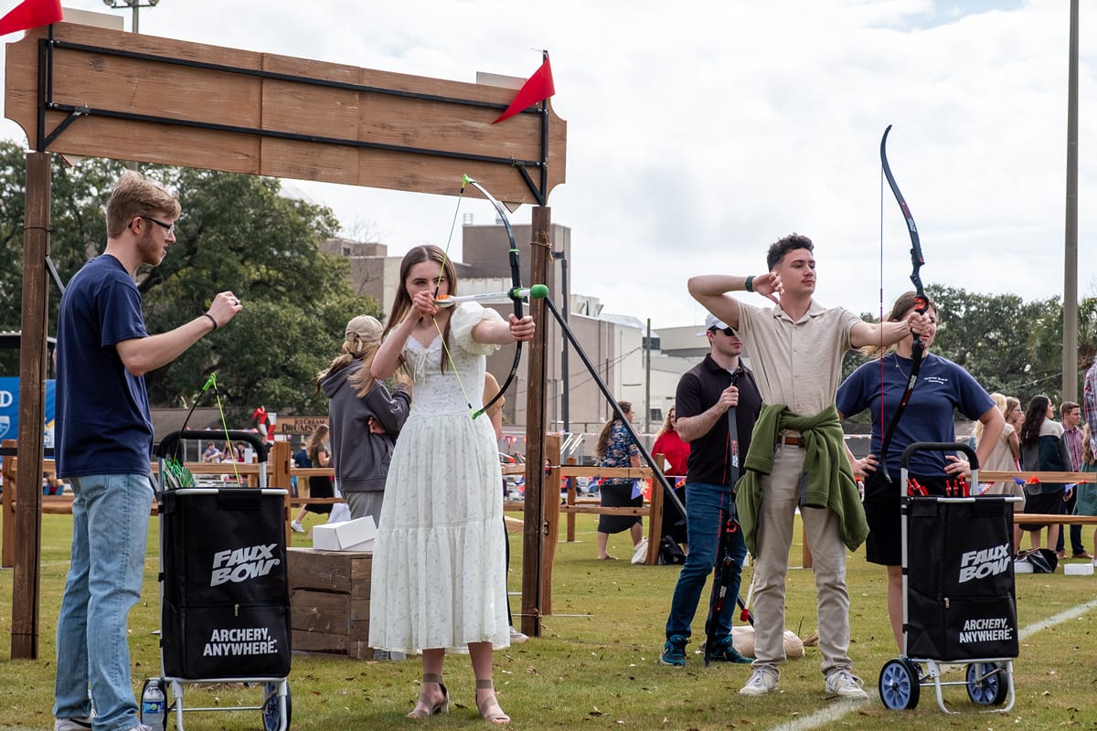 Students enjoying archery at the picnic