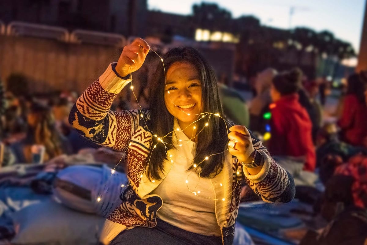 PCC Girl with string lights at Christmas Lights Celebration