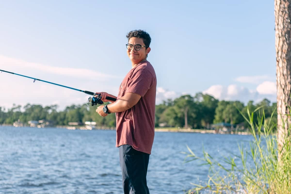 PCC Summer worker enjoys fishing during a West Campus student outing.