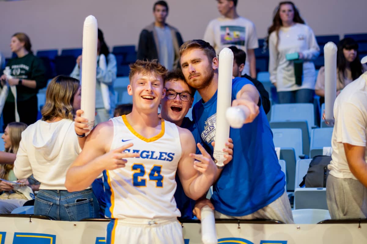 PCC eagle athlete and fan pose for a photo at Eagles Fan Fest