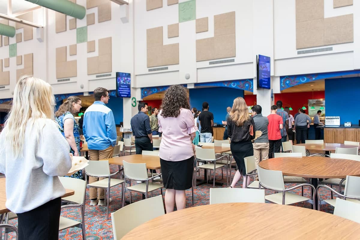 Students social distancing in dining hall lines