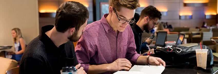 Male PCC students studying in the PCC Commons.