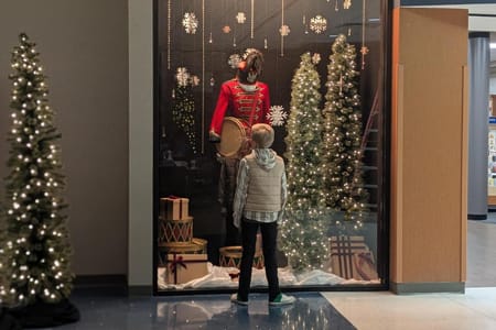 Boy admiring Little Drummer Boy costume in Campus Store Window