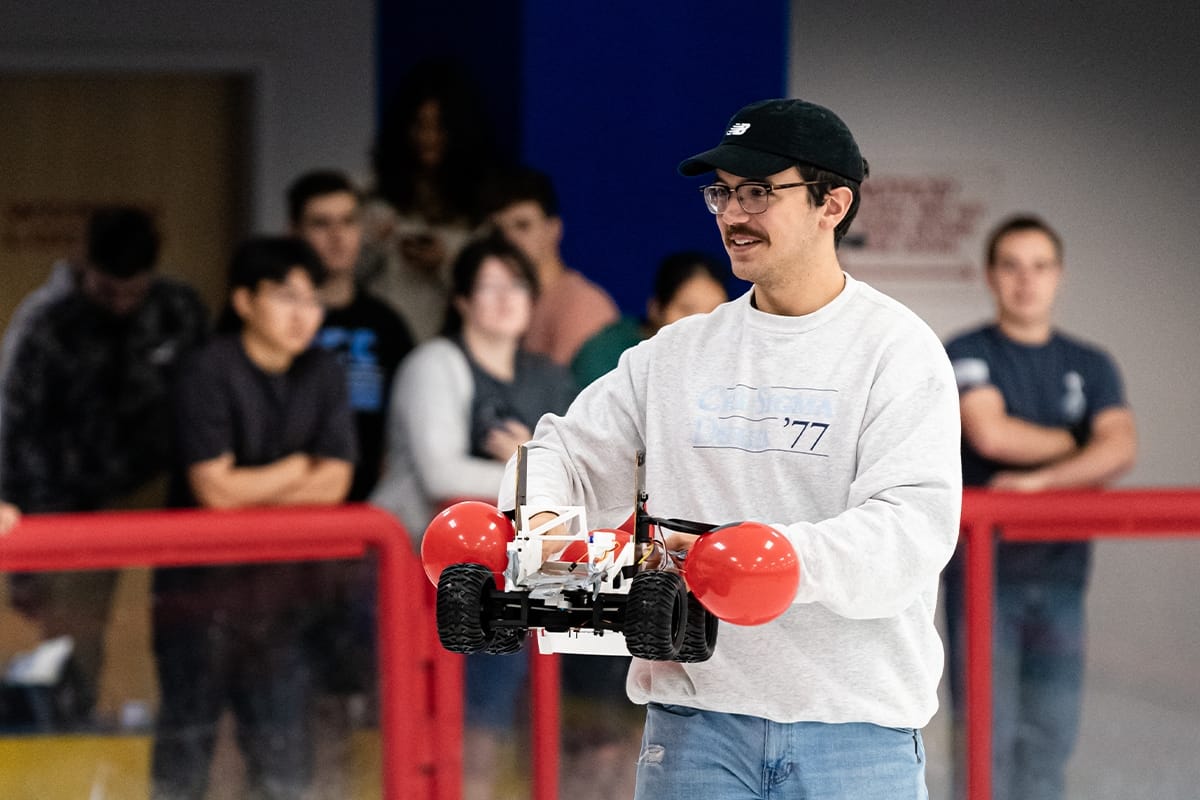 Students show robotic vehicle during Engineering Design Competition
