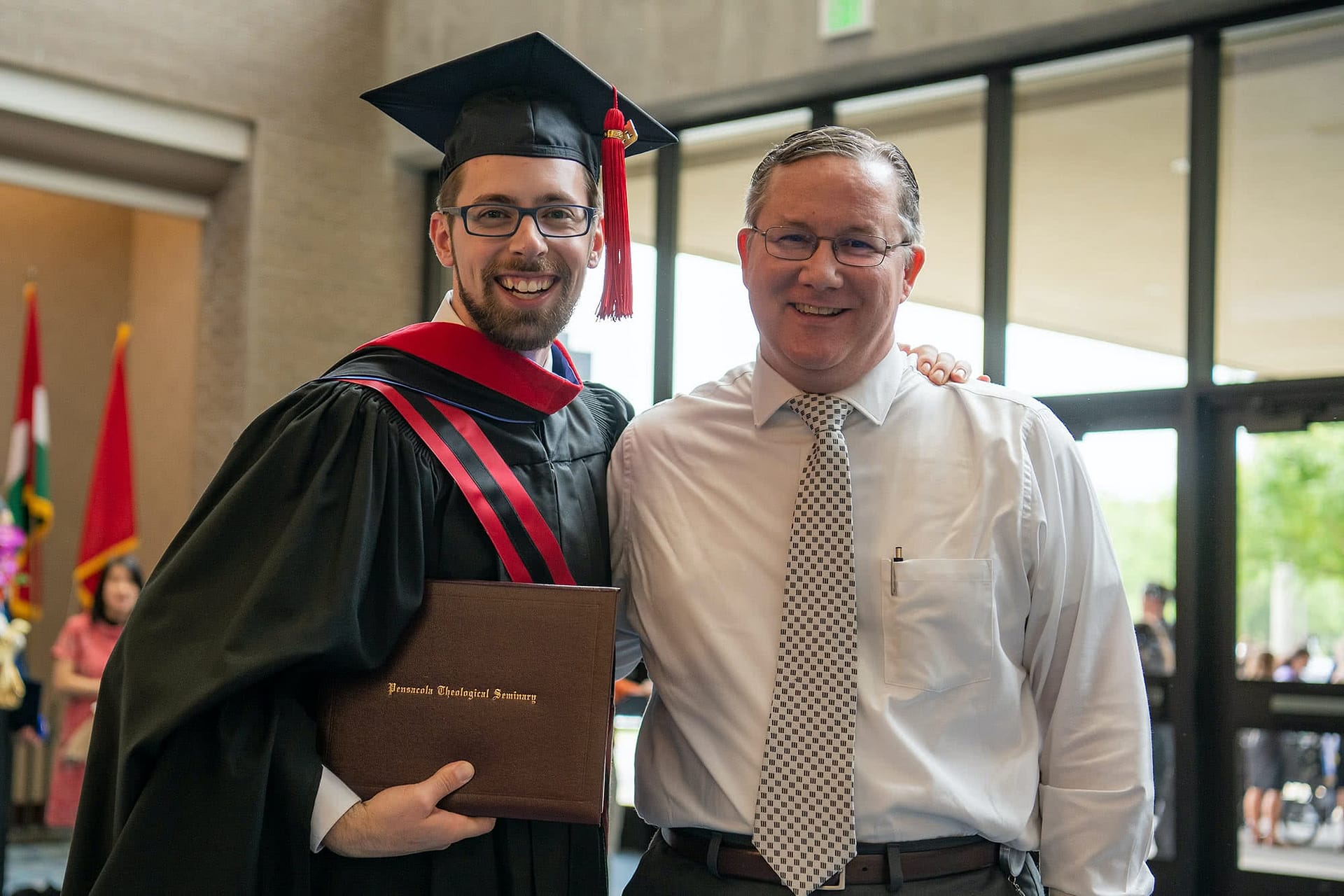 A Seminary graduate poses with a teacher