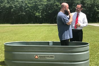 Dale Montgomery baptizing a man.