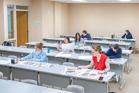 Students review the full layout of the Summit yearbook